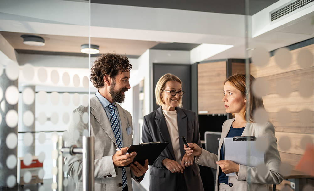Professionals discussing work indoors