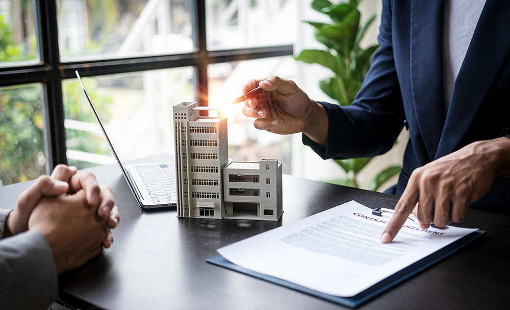 Business meeting with building model