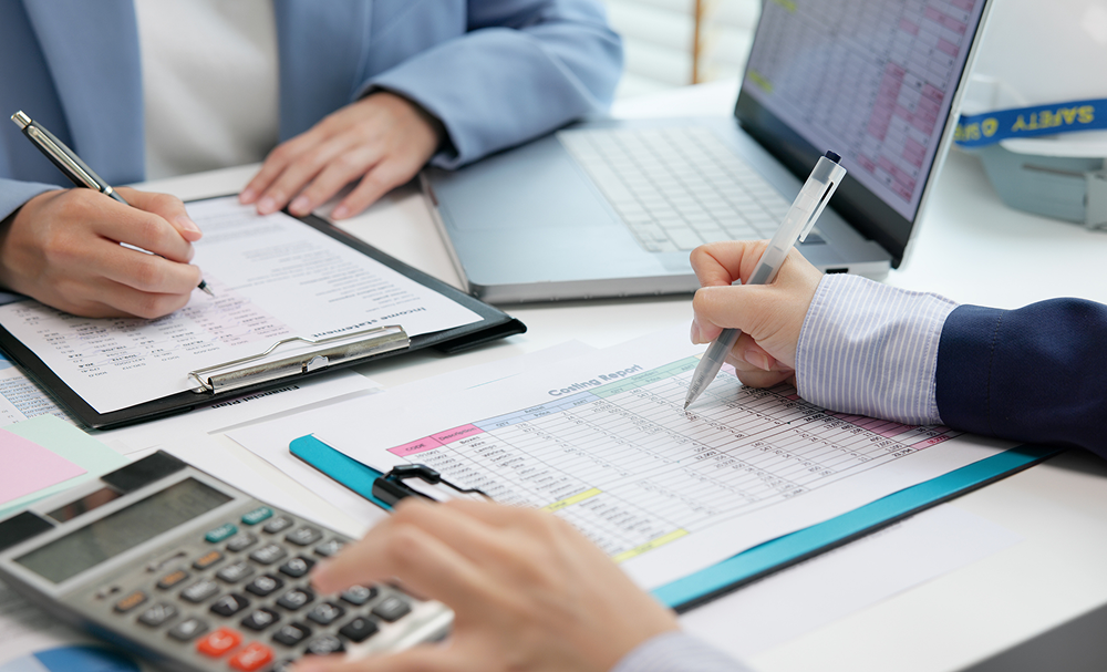 Team analyzing financial data with calculator