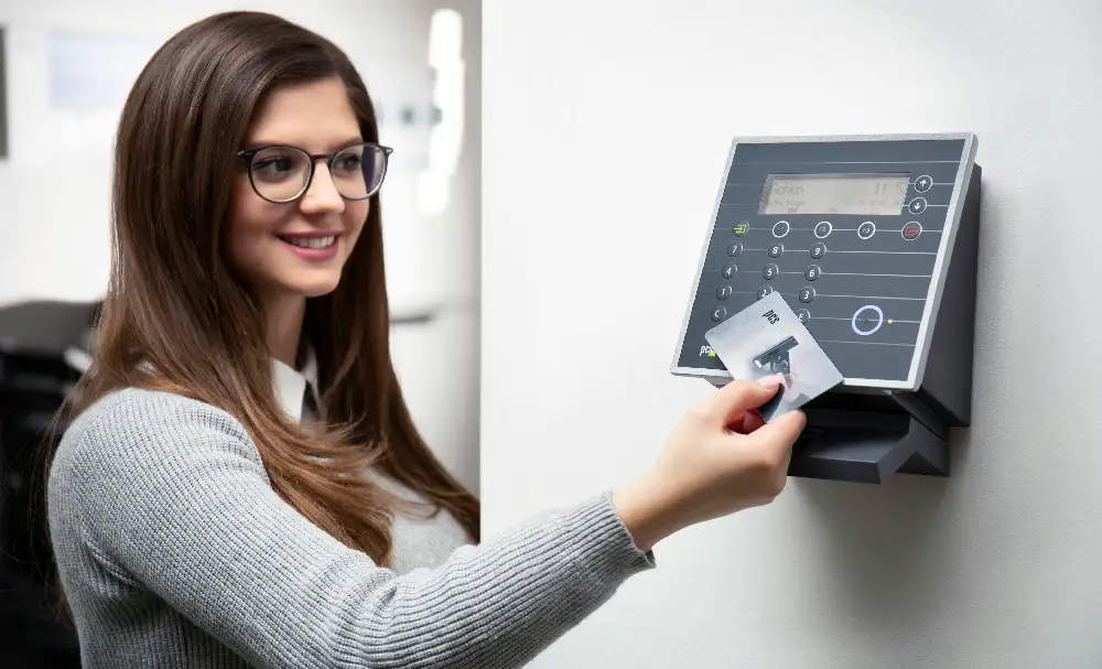 Woman using a card to access a secure digital panel.