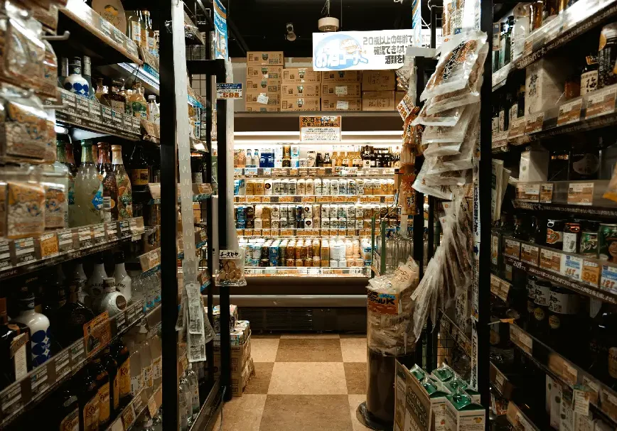 A narrow aisle in a grocery store stocked with various food items.