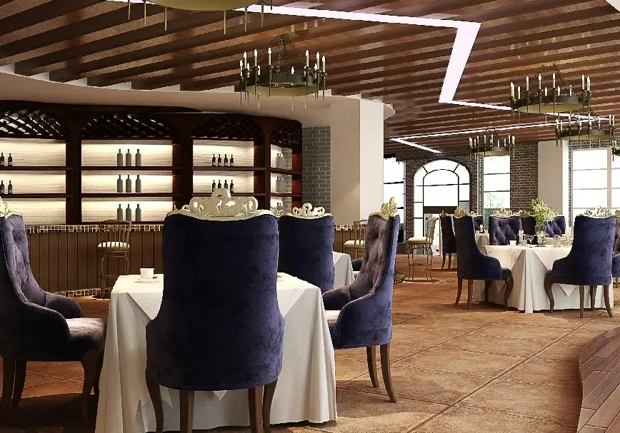 Elegant dining area with blue velvet chairs and wooden ceiling.